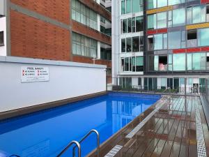 a swimming pool in front of a building at Imperial Garden2 in Auckland