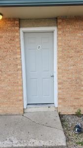 a white garage door with the number on it at Balgonie Motor Inn in Wolseley