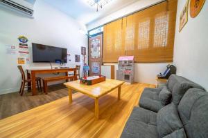 a living room with a couch and a table at FuqianRED in Tainan