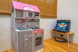 a toy kitchen and a tv in a room at FuqianRED in Tainan +40 photos