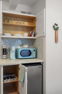 Una cocina con un microondas azul sobre una encimera. en Bright & Modern 2BR 2Bath Near SFSU & Transit, en San Francisco