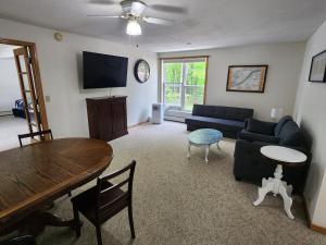 a living room with a couch and a table at Whispering Pines #1 in Calumet