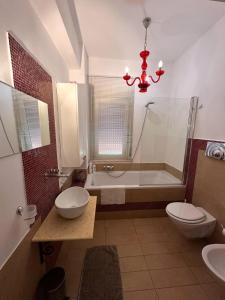 a bathroom with a tub and a toilet and a sink at La casetta di Ro Ro' Vista sulla Valle dei Templi in Agrigento +17 photos