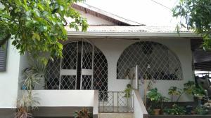 a white house with a cross on the front of it at Maria's Sanctuary in San Juan