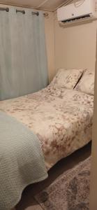 a small bedroom with a bed with a blanket at Maria's Sanctuary in San Juan