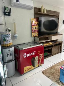 a living room with a tv and a box of snacks at Hotel e Pousada REQUINTTE in Parnaíba