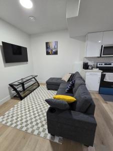a living room with a couch and a kitchen at Amazing 2-bedroom house with WiFi in Edmonton in Edmonton