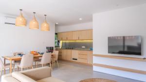 a kitchen and dining room with a table and chairs at Teras by Tamora in Badung