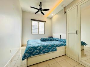 a bedroom with a bed and a ceiling fan at Suria Pantai Residency Kuala Lumpur in Kuala Lumpur +6 photos