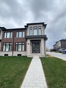 a brick house with a black door on a street at Best Choice for Travellers in Toronto