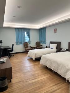 Postel nebo postele na pokoji v ubytování Menippe Hotel Kaohsiung