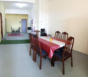 a dining room with a table with a red table cloth at WAQI Homestay in Miri