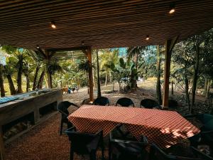 a table and chairs in a pavilion with a table and a table and chairs at Acampamento do Bosque in Rodeio