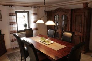 a dining room with a wooden table and chairs at Ferienwohnung Erika in Wimbach