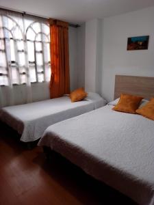Postel nebo postele na pokoji v ubytování Habitaciones C&S Bogotá