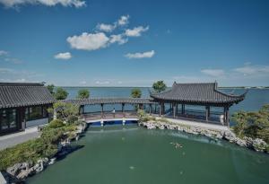 an overhead view of a building with a large pool of water at InterContinental Shanghai Harbour City by IHG in Nanhui