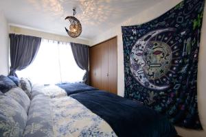 a bedroom with a bed with a blue and white blanket at Obbligato in Sapporo