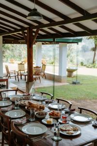 a wooden table with plates of food on it at The 6th Milepost Tea Bungalow Bandarawela in Bandarawela
