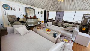 a living room with two couches and a table at Star Wars luxury camp in Wadi Rum