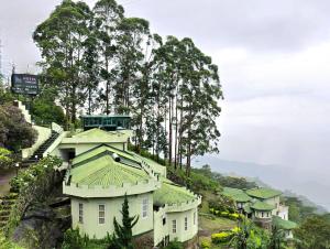 a group of houses on a hill with trees at Blackwood Hotel in Haputale