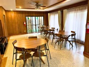 a dining room with wooden tables and chairs at Leonard Wood Pines Hotel in Baguio