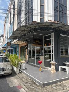 a building with a fire hydrant in front of it at Destiny House Hostel in Hat Yai