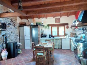 a kitchen with a table and chairs in a room at A fenera in Dolcedo