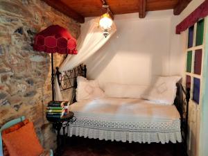 a bedroom with a bed in a room with a stone wall at A fenera in Dolcedo