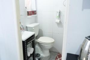 a small bathroom with a toilet and a sink at La Casa de Sol in Posadas +69 photos