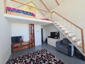 a living room with a bunk bed and a staircase at cabin view danau in Kejajar