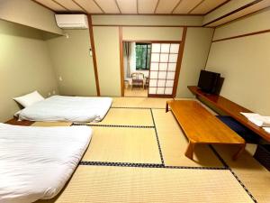 Postel nebo postele na pokoji v ubytování 富士たから荘 旭日館