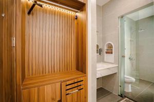 a bathroom with a shower with a toilet and a sink at Sunflower Hotel in Sầm Sơn +25 photos