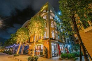 a large yellow building with christmas lights on it at Sunflower Hotel in Sầm Sơn