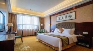 a hotel room with a large bed and a television at Xiangtan Xintian International Hotel in Xiangtan +170 photos