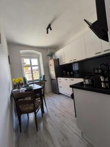 a kitchen with a table and a dining room at Neo Retro in Jelenia Góra