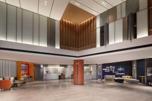 Un vestíbulo con sofás y sillas en un edificio. en 北京传媒大学希尔顿欢朋酒店Hampton by Hilton Beijing Communication University, en Beijing