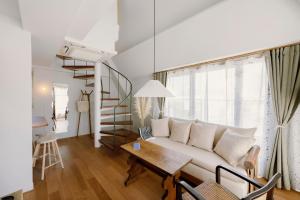 a living room with a white couch and a table at The Apartment Hotel 代々木1 in Tokyo