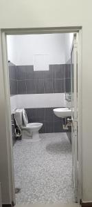 a bathroom with a toilet and a sink at Motel ANA in Cái Răng