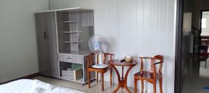 a room with two chairs and a table with a fan at Motel ANA in Cái Răng