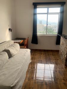 uma sala de estar com uma cama e uma janela em Centro, Maracanã privado total, SmarTV, vista panorâmica no Rio de Janeiro