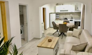 a living room and kitchen with a couch and a table at Sweet Hilltop Escape in Zelenika