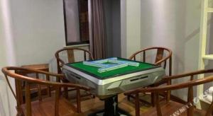 a table with a laptop sitting on top of it at Pai Hotel Huai'an Lianshui Huaipu Bei Road in Lianshui