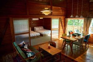 a living room with a table and a bedroom at nasusatoyamafield in Otawara