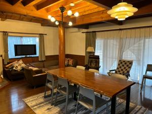 a living room with a wooden table and chairs at nasusatoyamafield in Otawara