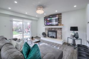 a living room with a couch and a fireplace at Modern Designed 1BR Studio in Quite Neighborhood in Richmond Hill