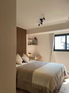 a bedroom with a large bed and a window at Art08 Milu - Miraflores Cerca de Larcomar in Lima