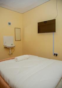 a bedroom with a white bed and a sink at Stylish Mauve Studio with free WI-FI in Nanyuki