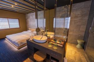 a bathroom with a bed and a sink and a shower at Kinnotake Saryo in Hakone +53 photos