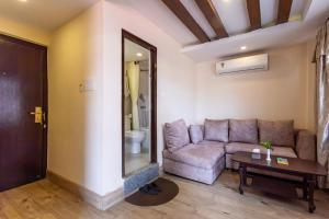 a living room with a couch and a table at Hotel Sapana Garden Thamel in Kathmandu