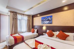 a hotel room with two beds and a window at Hotel Sapana Garden Thamel in Kathmandu
